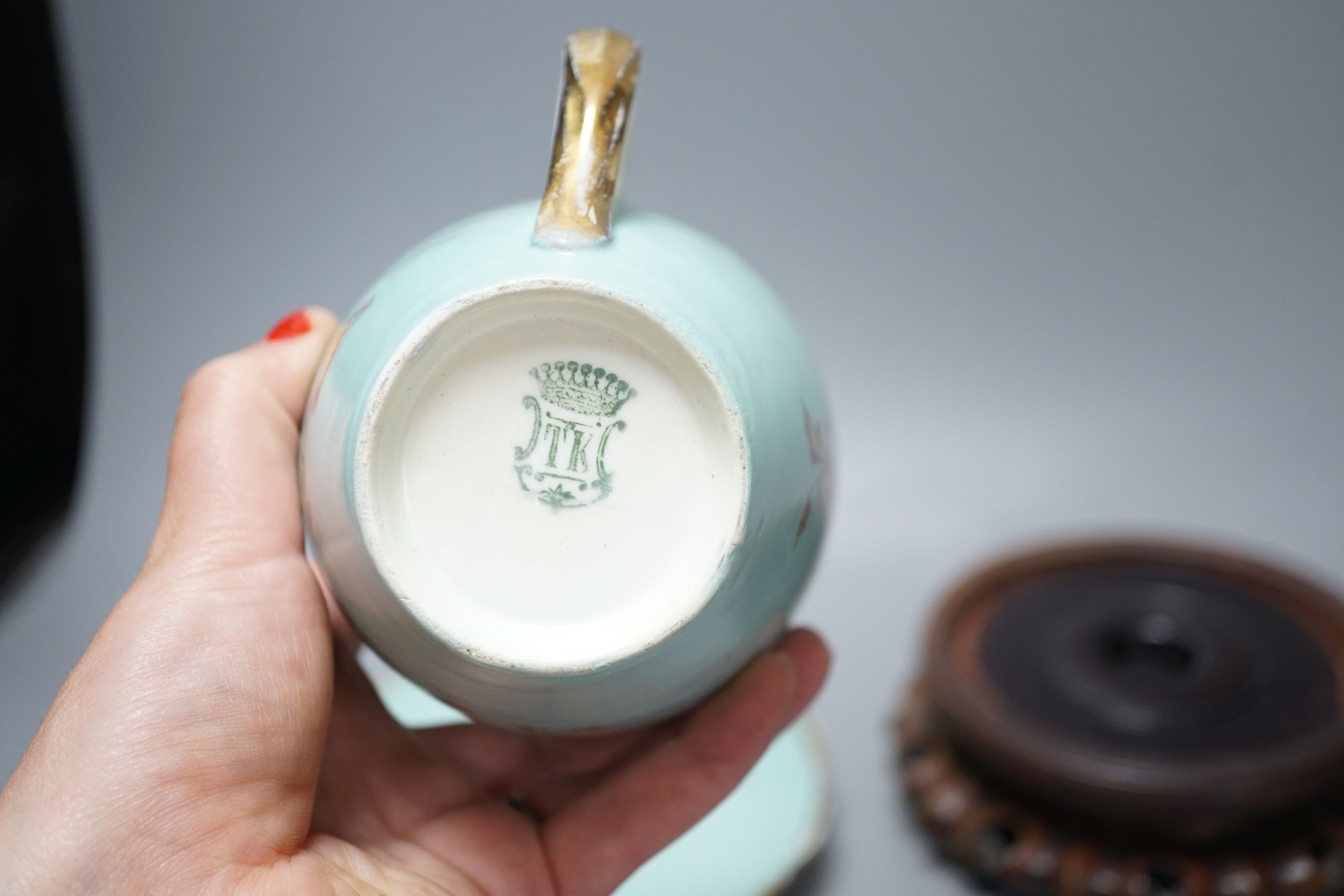 A Continental porcelain jam pot, 15cm tall, and cover with stand, together with 2 Chinese hardwood stands, enamelled plate and another (7)